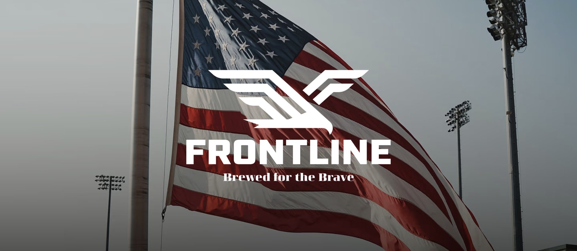 An American flag flying over a ballpark with the Frontline Brewed for the Brave logo