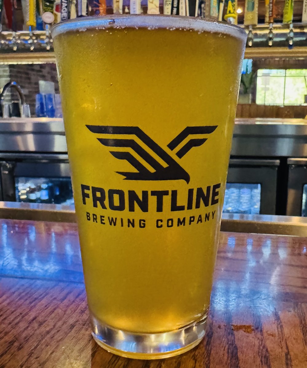 A fresh pint of Frontline American Lager on the bar